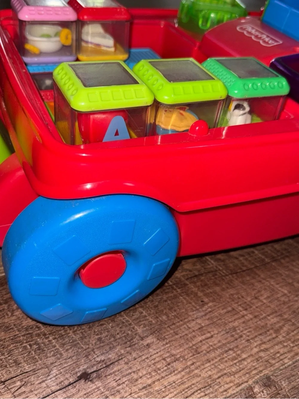 Vintage Fisher-Price Peek-a-boo Pull Toy with Green Handle and Blue Wheels